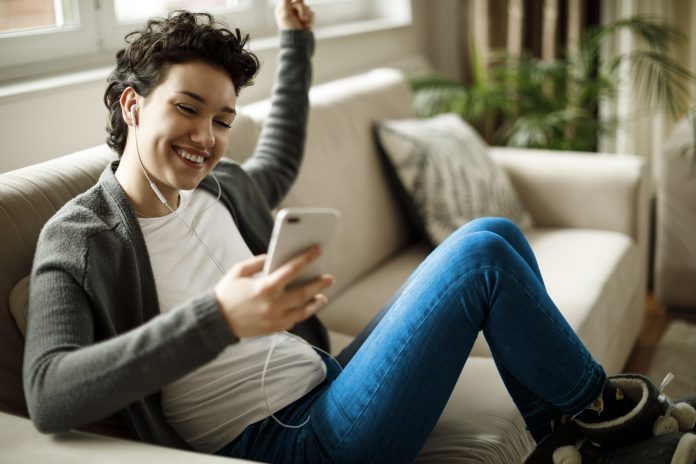 Young woman enjoying music at home